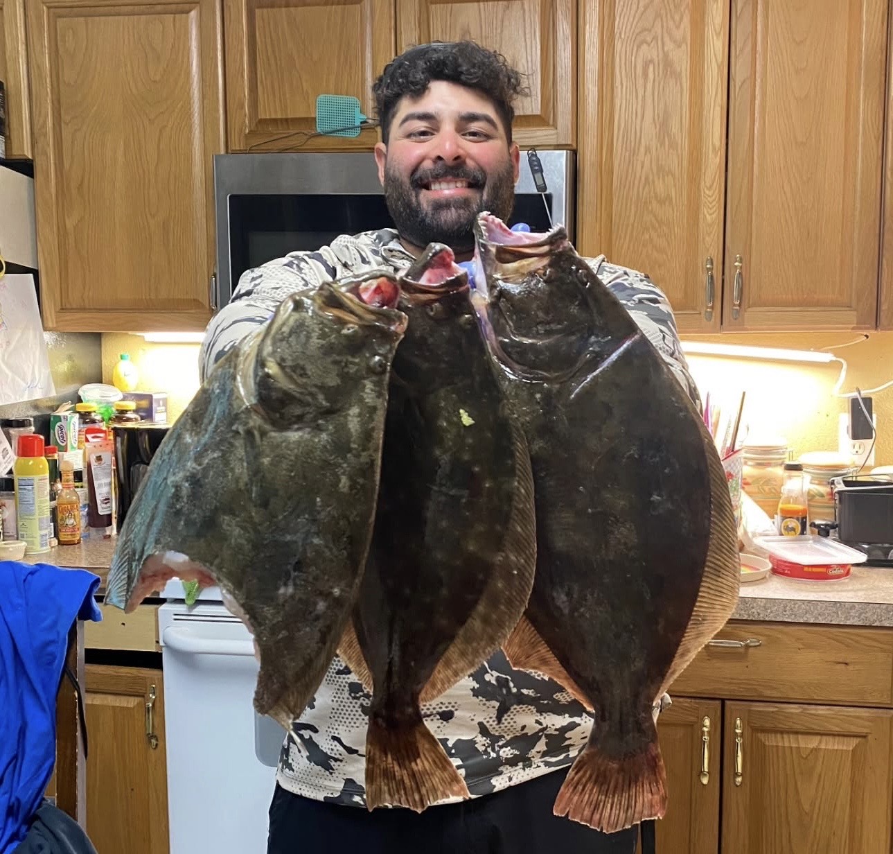 John Jo holding two flounder